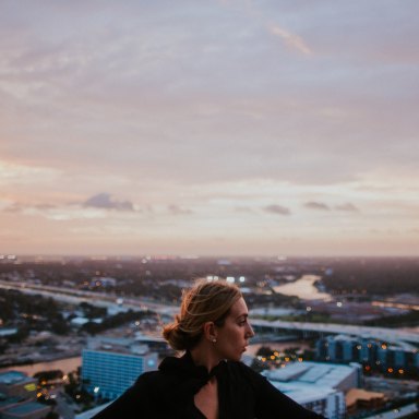 girl at sunset looking at city skyline, losing you, becoming whole