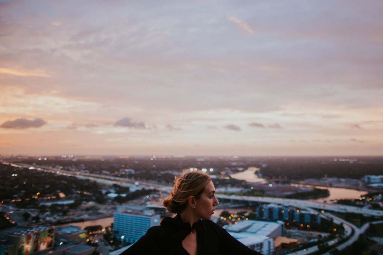 girl at sunset looking at city skyline, losing you, becoming whole