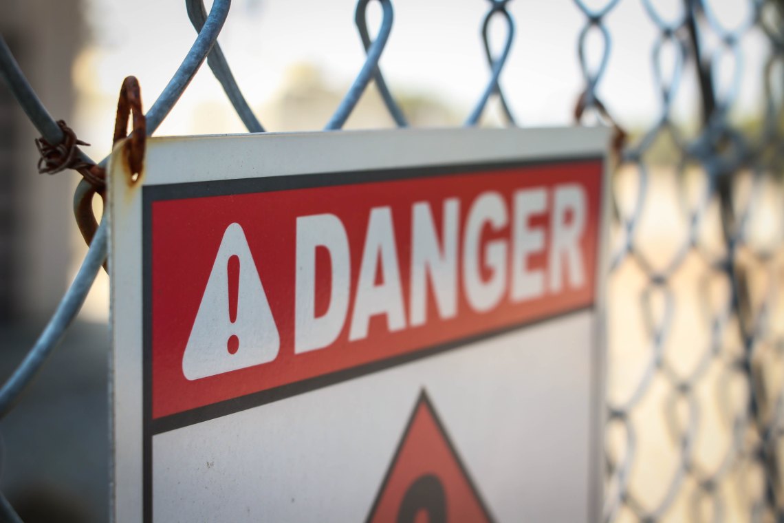Danger sign on a fence
