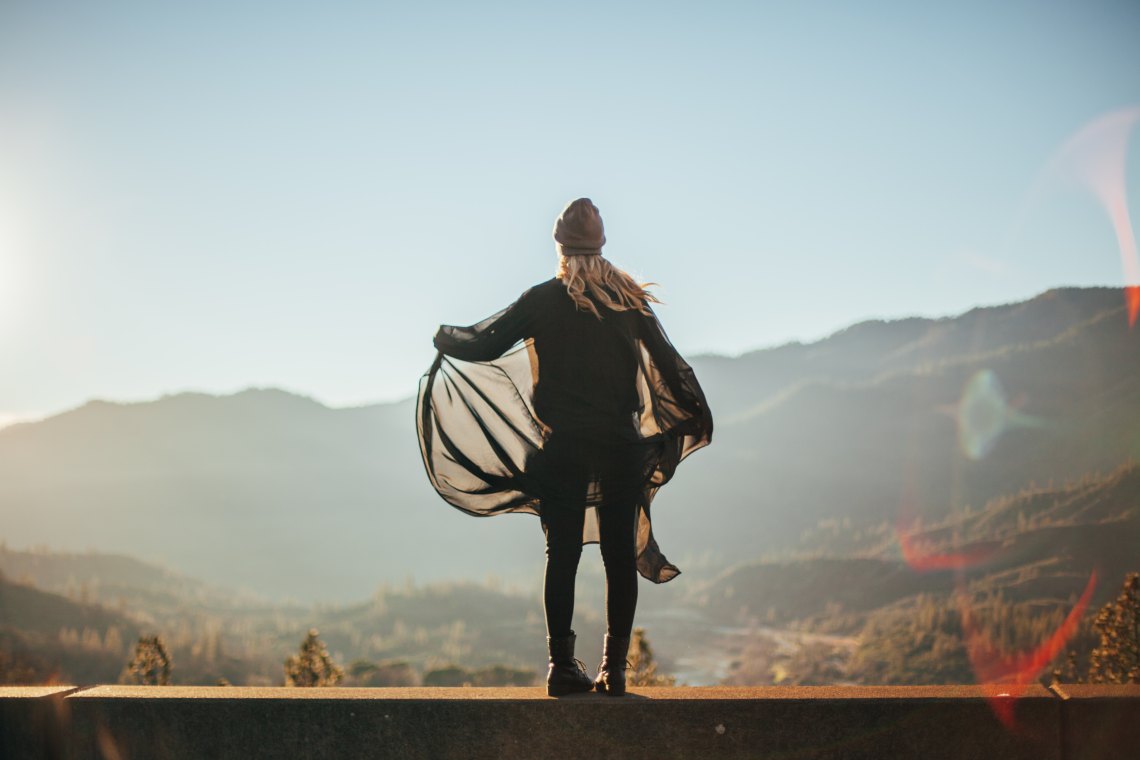 Woman standing over mountain ledge