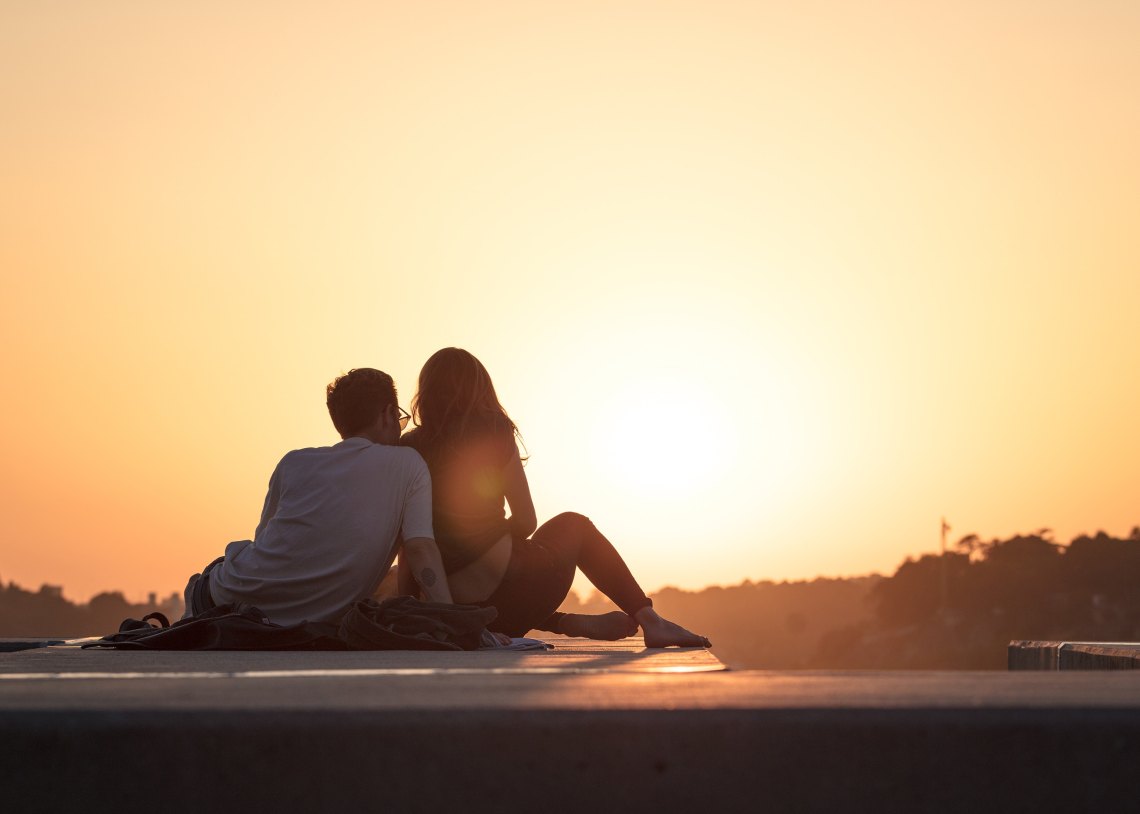 couple sitting together at sunset, marriage advice, couple advice