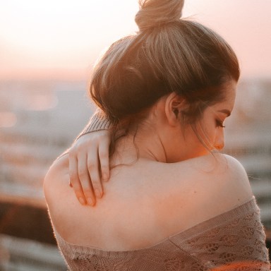 girl with hand on her back, girl in sunset, finding joy