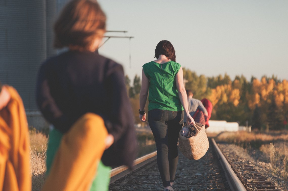 People walk across a bridge together