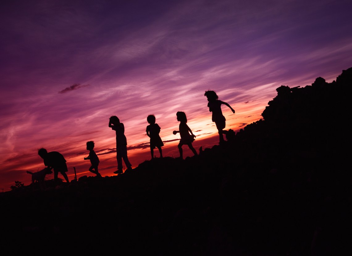 children running in the sunset