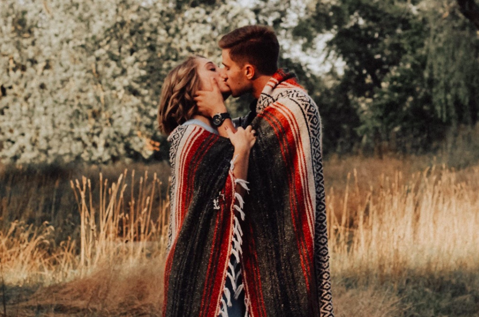 Couple kissing under blanket