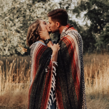 Couple kissing under blanket