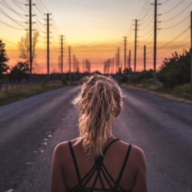 girl at a crossroads, girl looking at road, trusting the road ahead