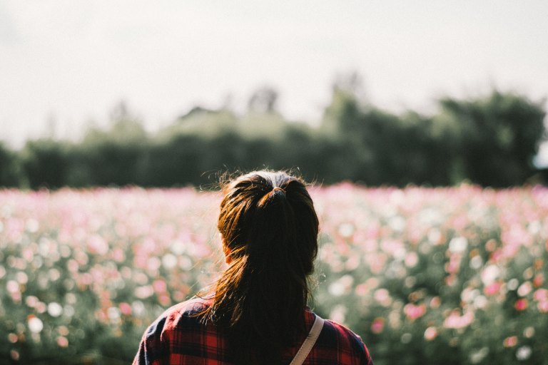 Woman standing in field of flowers
