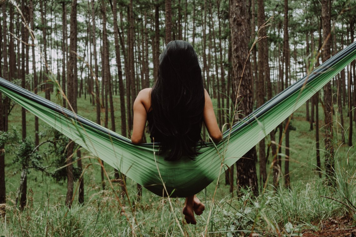 Woman in hammock in woods