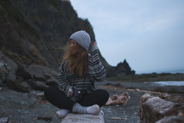 girl sitting by rocks, quotes about gratitude, being thankful