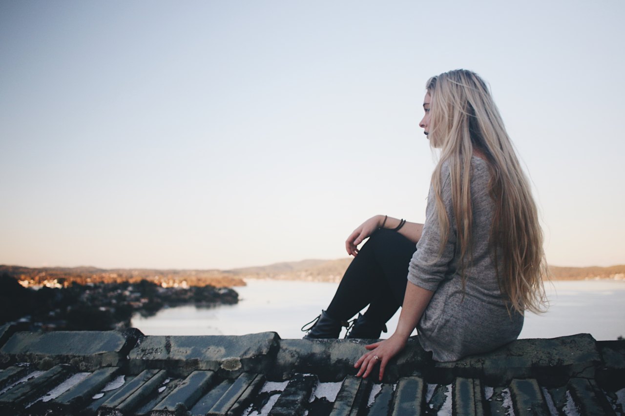 woman standing alone, reflecting on a toxic relationship