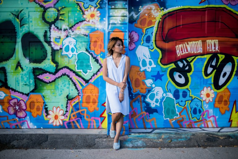 girl standing by graffiti wall, sensitive, sensitive and strong