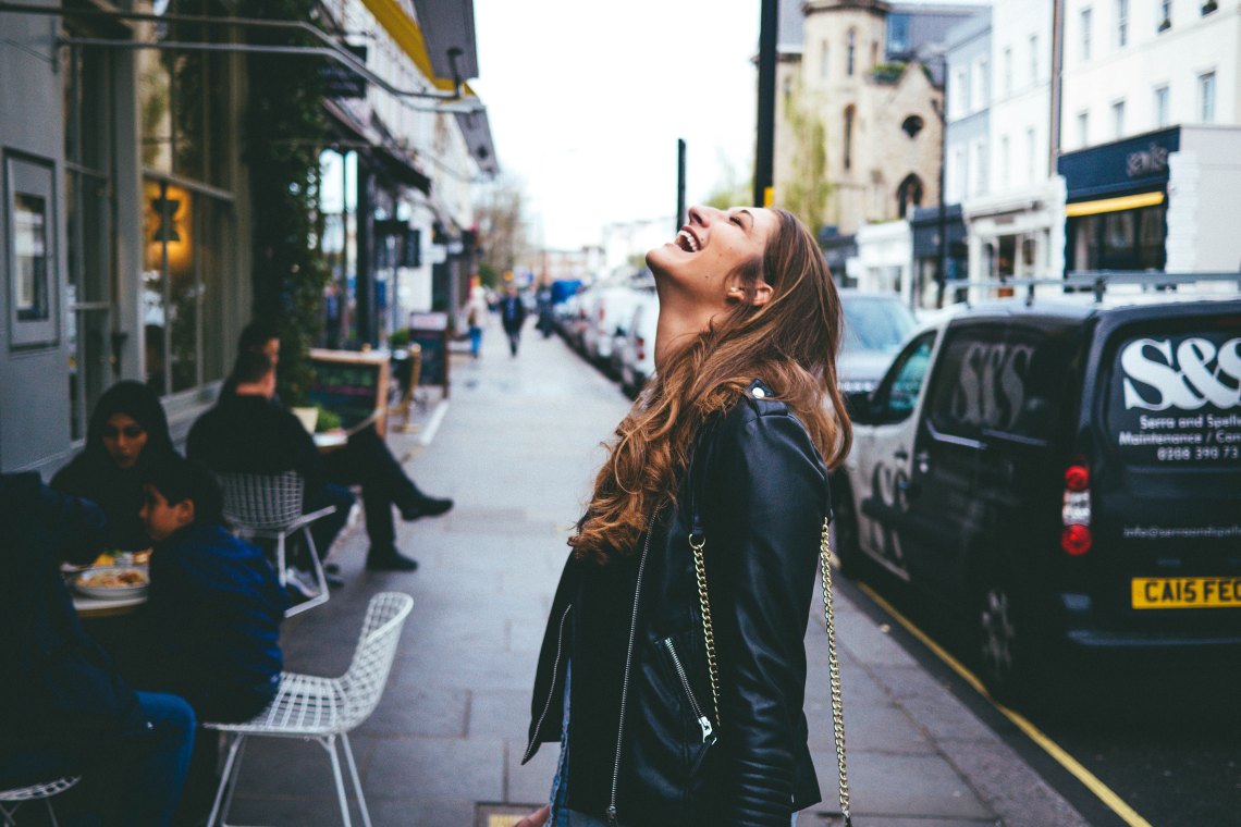 Woman laughing in street