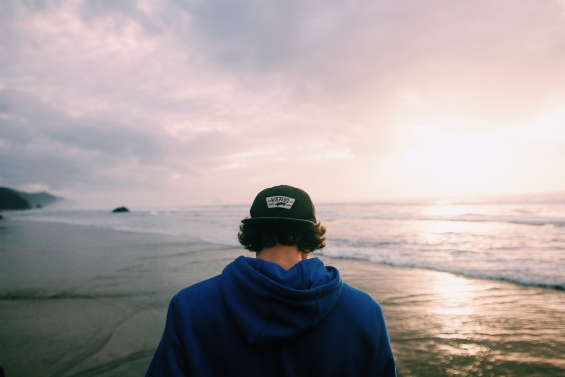 Guy standing over ocean