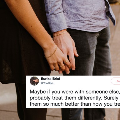 A couple holds hands, though the man looks distant