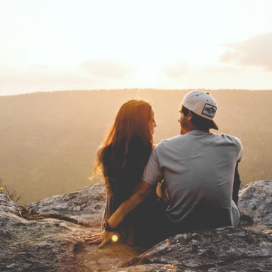 Couple hugging on mountaintop