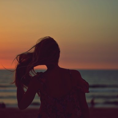 Woman's silhouette in front of ocean
