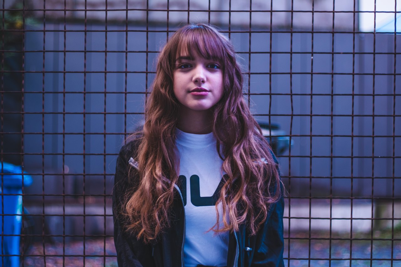 Woman standing in front of fence