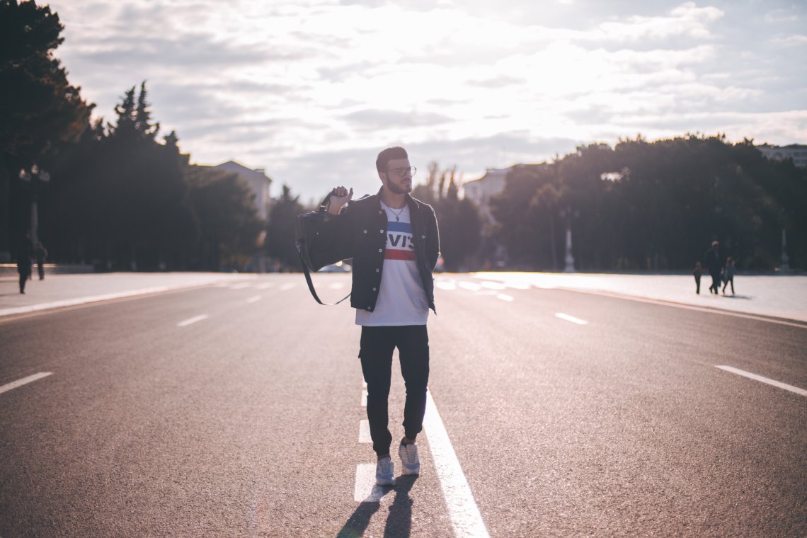 man walking on road