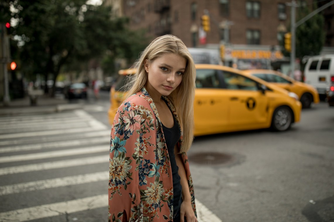 blonde woman in front of taxi