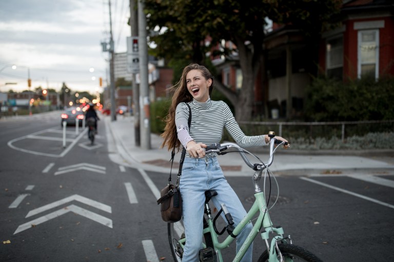 happy girl riding bike in the city
