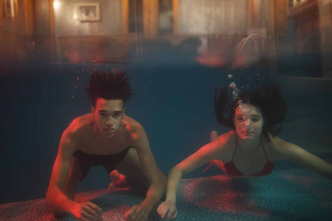 two people in a pool underwater