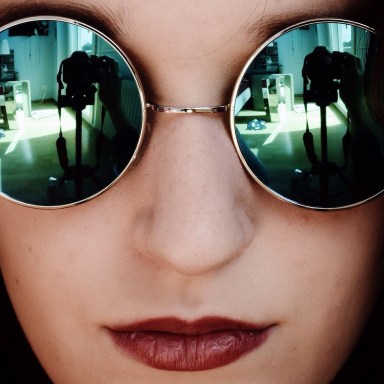 Cool young woman taking selfie with red lipstick and sunglasses