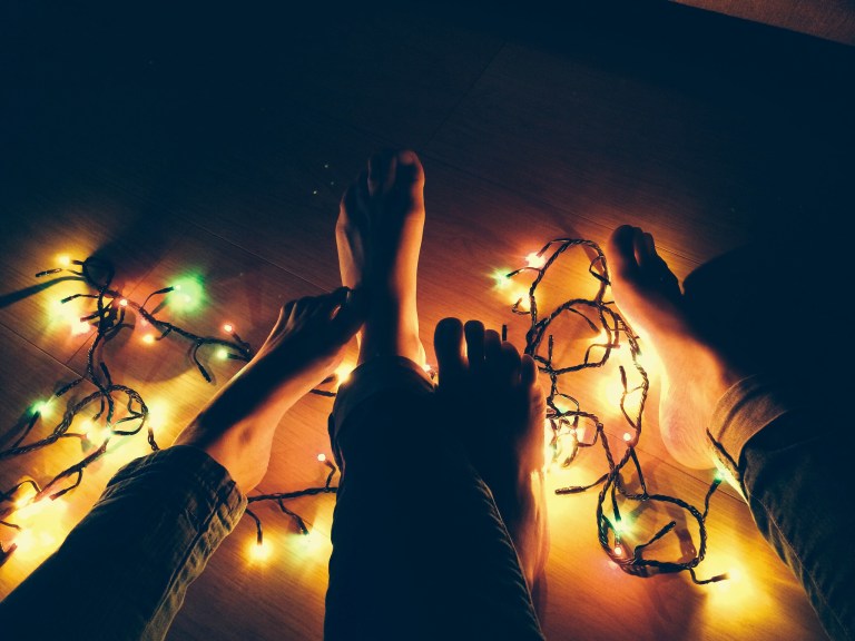 christmas lights and couple feet and legs