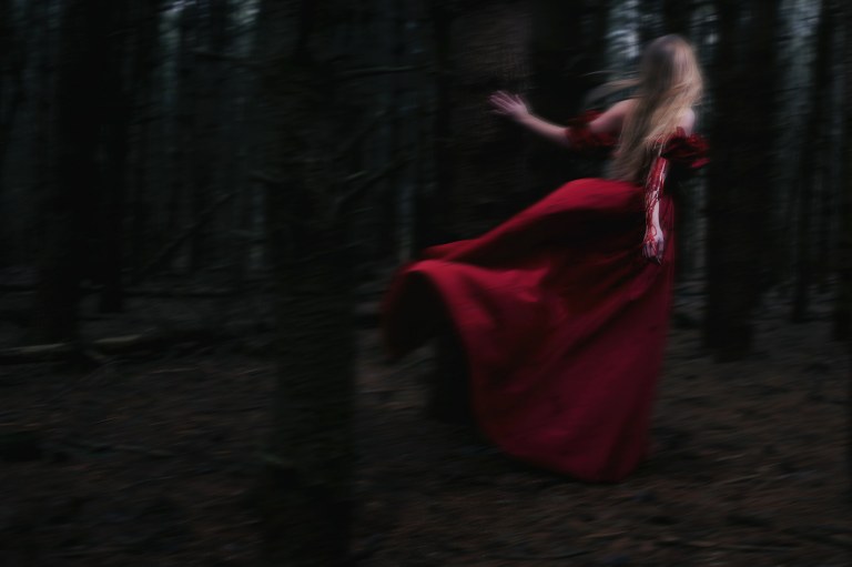 Blood red blurry female fleeing in gown