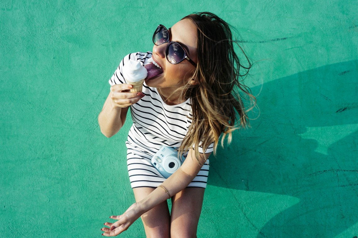portrait girl poloroid eating ice cream on green wall summertime summer dress