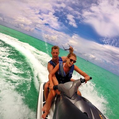 couple riding on jetski having fun