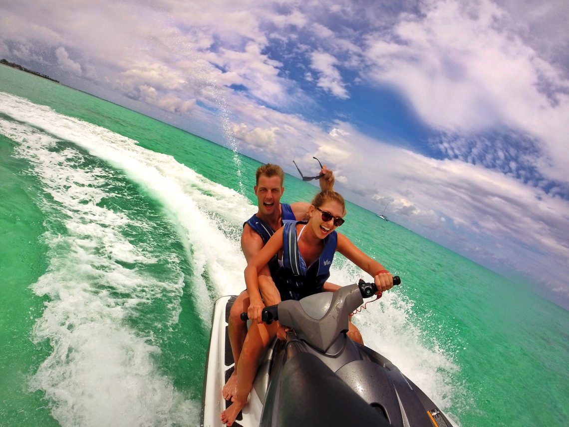 couple riding on jetski having fun