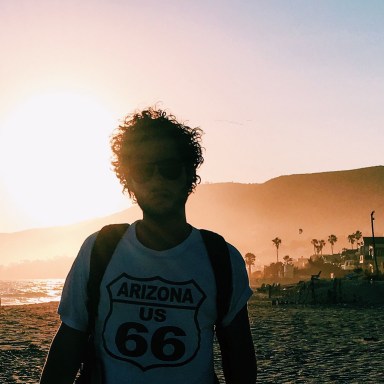 guy in route 66 arizona t-shirt in the summer sunset on the beach