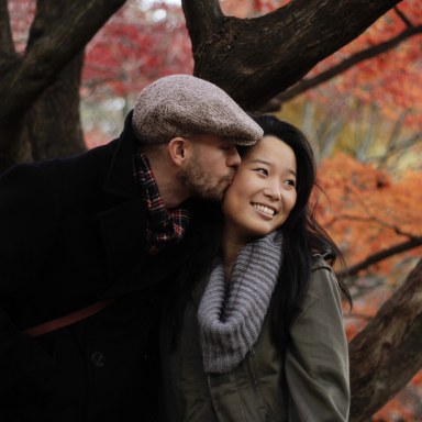autumn couple kissing on the cheek
