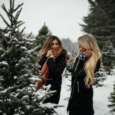 friends laughing at a christmas tree farm