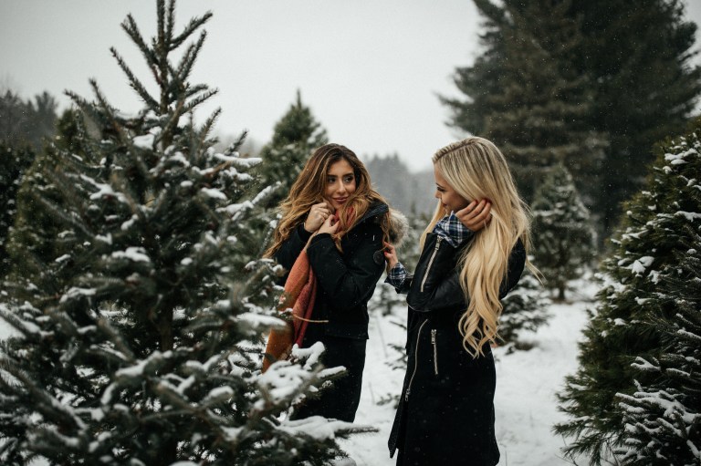 friends laughing at a christmas tree farm