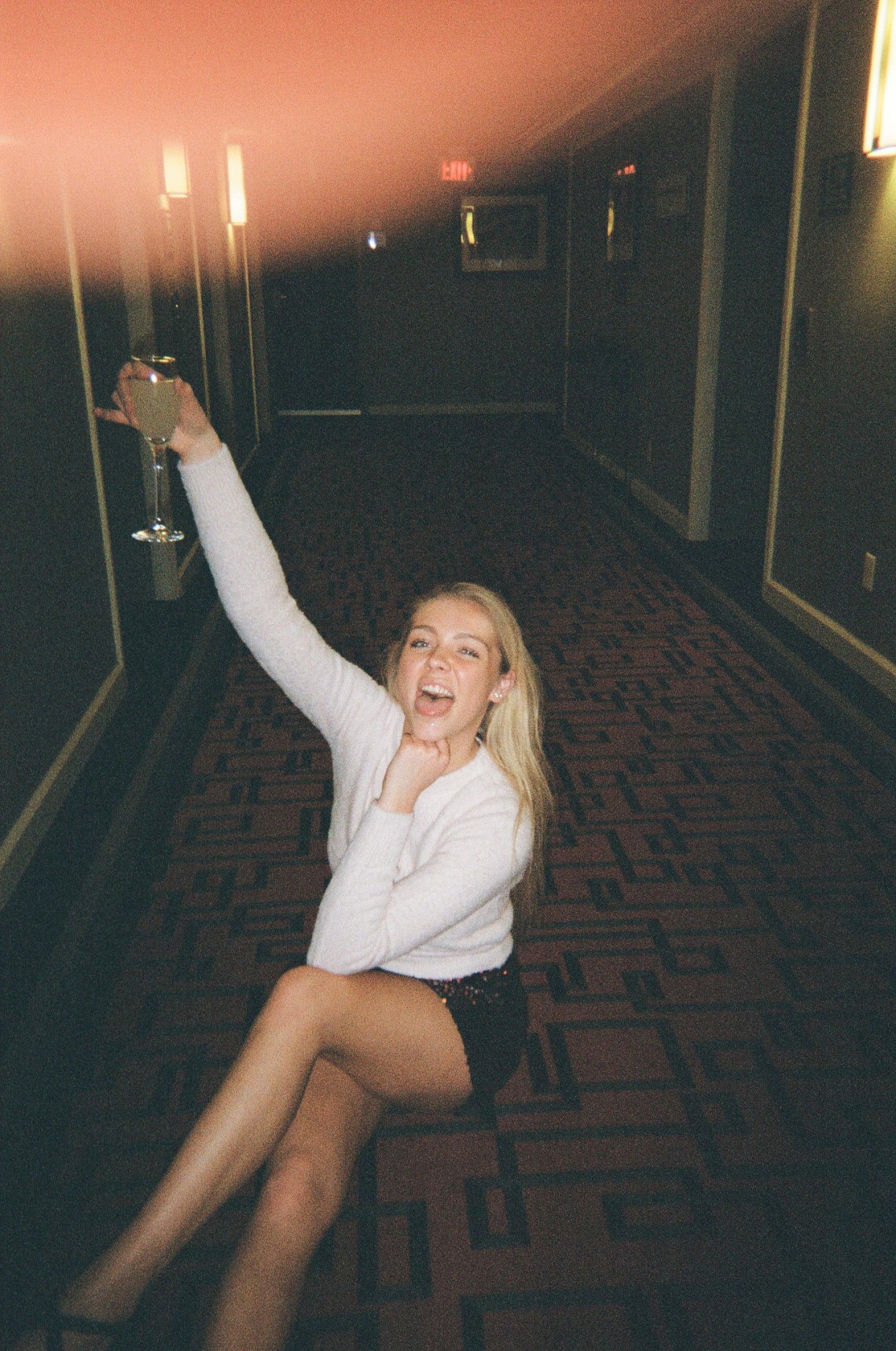 girl cheersing with a glass of champagne 