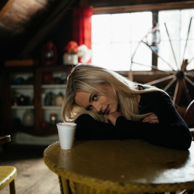 blonde girl in a cabin drinking coffee