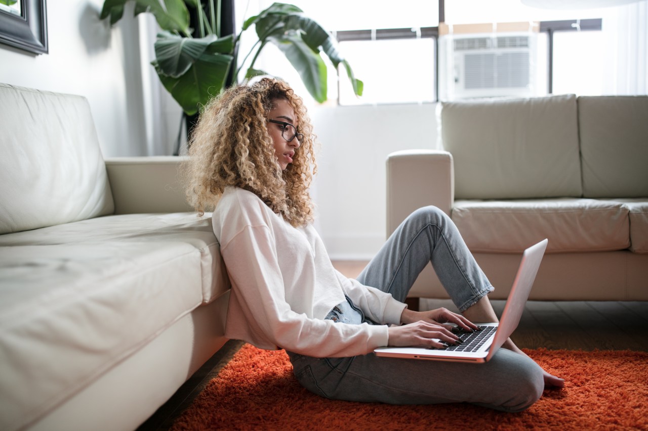 woman sitting on floor on laptop