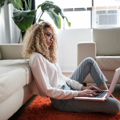 woman sitting on floor on laptop