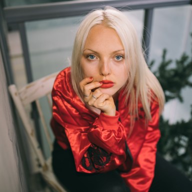 woman with red lips sitting in chair