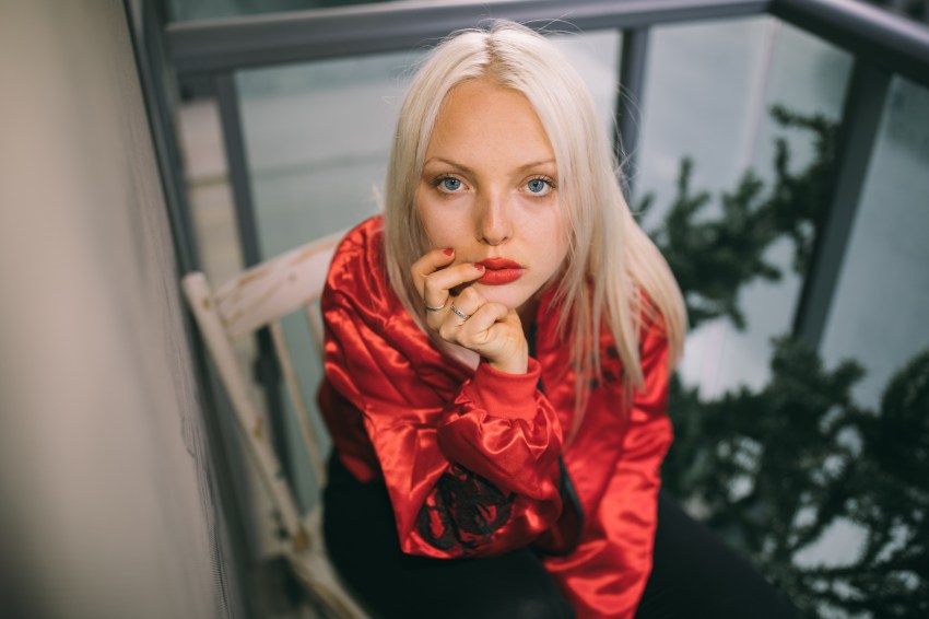 woman with red lips sitting in chair