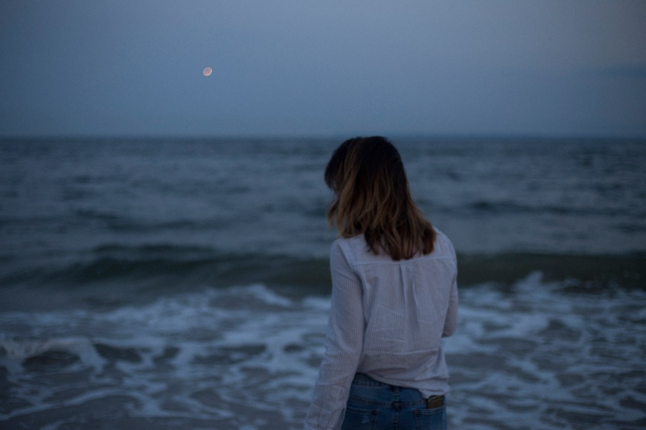 Woman looks out at the ocean