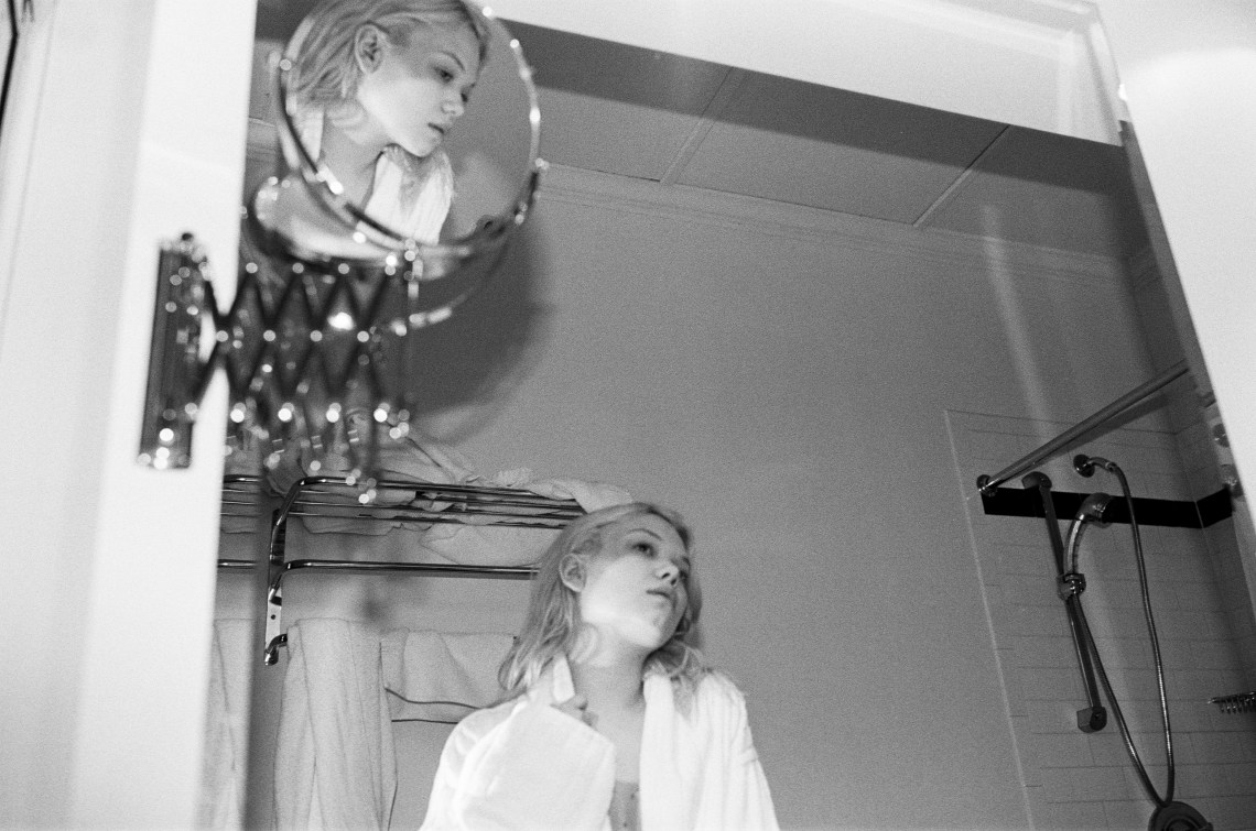 woman looking depressed staring in mirror