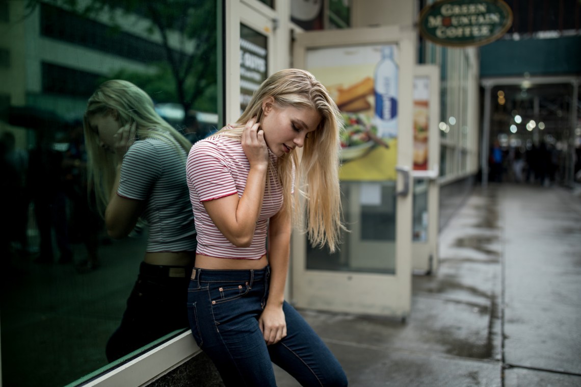 woman in striped red shirt looking down