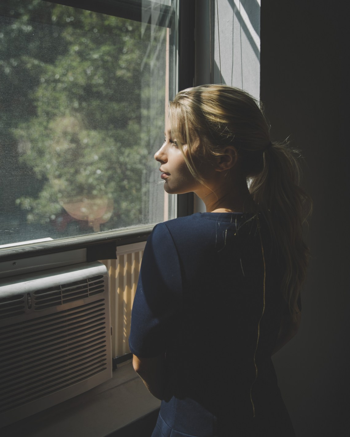 woman looking out the window