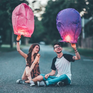 couple sitting with lanterns in street