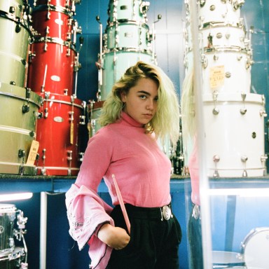 woman standing in front of drums