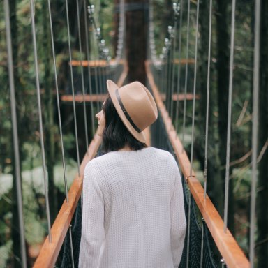 girl wandering down a bridge