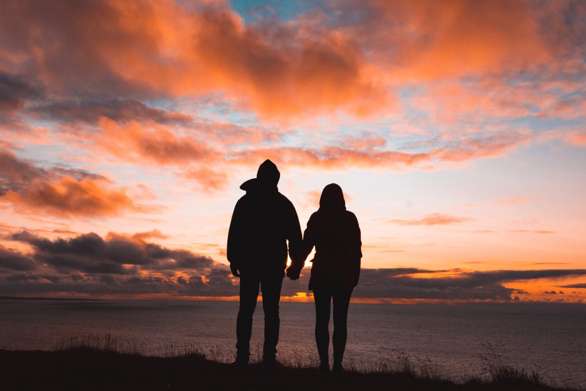 couple standing at sunset